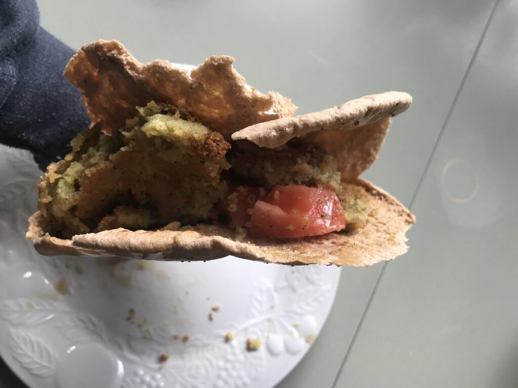Pita pocket with falafel partly eaten