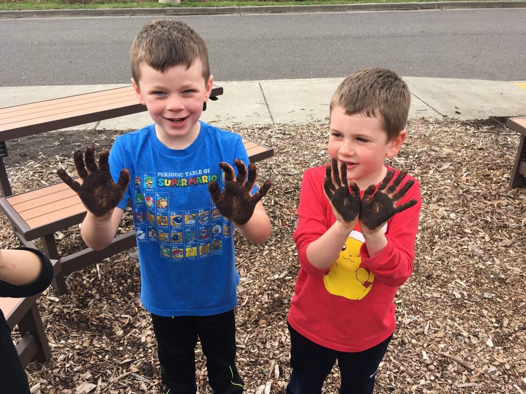 Two boys with dirty hands